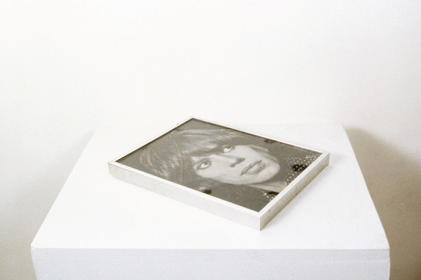 BLOW<br />
1982 Ongoing<br />
Aluminum Framed Black and White Glossy Photograph of Mick Jagger Used as a Cocaine Tray by the Artist and Acquaintances During the '80's and Left Uncleaned with Drug and Saliva Residue on Top<br />
8 1/2” x 11” x 1”<br />