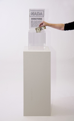 “PAY WHAT YOU WISH BUT YOU MUST PAY SOMETHING”<br />
2013 Ongoing<br />
Floor: One of 18 Functioning American Art Museum Donation Boxes replicated and Displayed at an Art Fair in Various Positions throughout the Fair<br />
NADA Art Fair<br />
Variable Dimensions<br />
