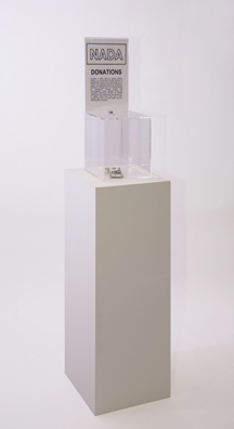 “PAY WHAT YOU WISH BUT YOU MUST PAY SOMETHING”<br />
2013 Ongoing<br />
Floor: One of 18 Functioning American Art Museum Donation Boxes replicated and Displayed at an Art Fair in Various Positions throughout the Fair<br />
NADA Art Fair<br />
Variable Dimensions<br />