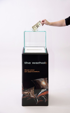 “PAY WHAT YOU WISH BUT YOU MUST PAY SOMETHING”<br />
2013 Ongoing<br />
Floor: One of 18 Functioning American Art Museum Donation Boxes replicated and Displayed at an Art Fair in Various Positions throughout the Fair<br />
Andy Warhol Museum<br />
Variable Dimensions<br />
