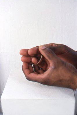 FOREVER <br/>
1977 Ongoing <br/>
Detail: Artist's Latchless Edwardian “Forever” Bracelet Being Tried on by Oneil Edwards<br/>
7 1/2” in Diameter <br/>