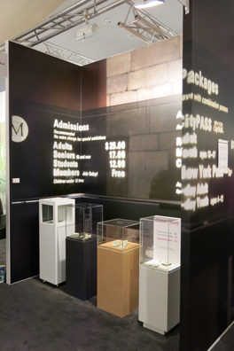 “PAY WHAT YOU WISH BUT YOU MUST PAY SOMETHING”<br />
2013 Ongoing<br />
Booth Installation Replicating 4 of 18 American Art Museum Donation Boxes for the Commercial Art Fair NADA<br />
Wall: C Print of Wall Mural of the Metropolitan Museum of Arts Entry Policy<br />
Floor: Donation Boxes of San Diego Museum of Contemporary Art, Clyfford Still Museum, Aspen Art Museum, Contemporary Art Museum Houston: 4 of 16 American Art Museums that Did Participate in the Artist’s Invitation to Collaborate<br />
Variable Dimensions<br />