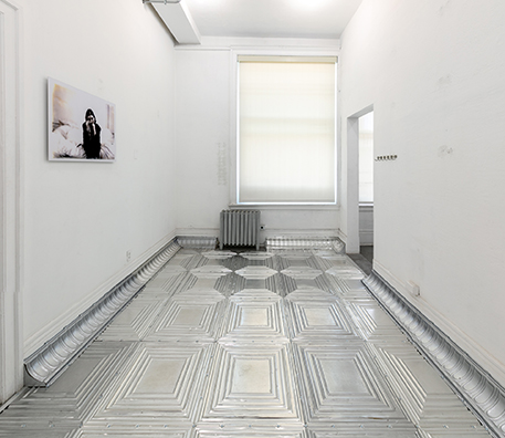 ONCE UPON A TIME<br />
1994 Ongoing<br />Floor: American Prest-Plate Ceiling Tin Installed on Top of Gallery Floor Left for Viewers to Destroy through Abrasion with Actual Gallery Floor, Viewer Imprints, Tracks, and Traffic <br />
Variable Dimensions