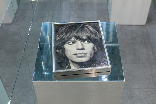 BLOW<br />
1982 Ongoing<br />Aluminum Framed Black and White Photograph of Mick Jagger Used as a Cocaine Tray by the Artist and Acquaintances During the ‘80s and Left Uncleaned with Drug and Saliva Residue on Top<br />
8 x 11 x 1 inches