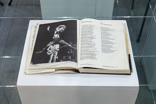 MISS AMANDA JONES<br />
2000 Ongoing<br />The Artist’s Rolling Stone Song Book Opened to the Page Where the Song, “Miss Amanda Jones” Appears – a Tribute to the Famous Transsexual, Muse, and Model, Amanda Lear<br />
14 x 10 x 1 inches