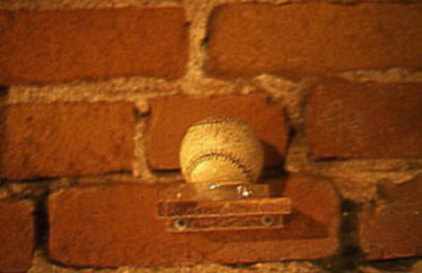 TOUCH OF GREATNESS: BABE RUTH<br/> 
2000 Ongoing<br/>
Wall: Autographed Baseball from the Artist's Personal Collection: Babe Ruth <br/>
Left Unguarded to Collect Visitors' Fingerprints, Diminishing in Value as a Collectible, while Increasing in Value as an Art Object<br/>
Dimensions: Regulation American League Baseball <br/>
Edition: 3<br/>