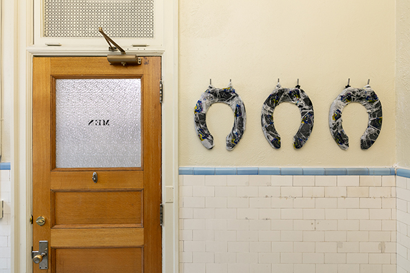 HORSESHOES, HAND GRENADES, AND DANCING<br />
2020 Ongoing<br />
Series of 3 Toilet Seats, Wrapped in Scott Toilet Paper Packaging, Mounted on Wall of Men’s Bathroom<br />
Variable Dimensions