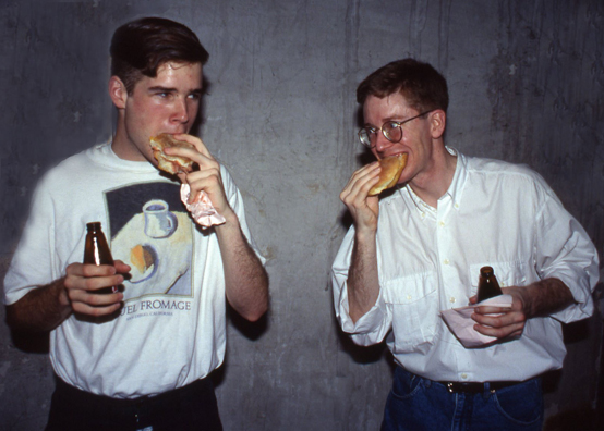 “ONE LITTLE PIGGY ATE ROAST BEEF, ONE LITTLE PIGGY HAD NONE” <br />
1991 Ongoing<br />
Happening: 100 Pounds of Roast Beef, Sliced, Served in Sandwiches, and Consumed in Variable Dimensions <br />
Photograph of Happening: Chris Malstead and Bill Griswold “Get Down on It”<br />