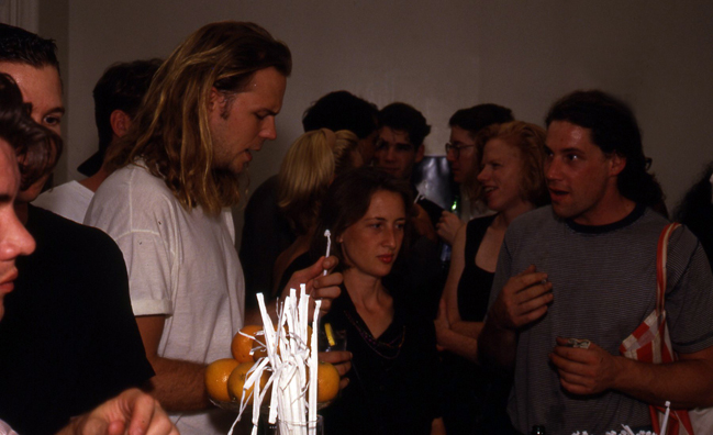 SUCK<br />
1991 Ongoing<br />
Happening: Plastic Straws with Fancy Handmade Paper Tops Served in All Drinks at Various Art Fairs and Art Openings, Displayed in Bouquets in Bar Area, and as Relics<br />
Series of 10 “Straw Bouquets”, 500 Individual Straws/Bouquet<br />
Photograph of Happening NY: John Currin and Eric O Think About The Fierce Jelly Doughnut Aroma<br />
Edition: 2, 1 AP<br />