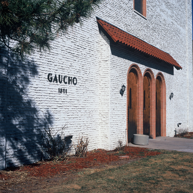 DISPLACED DENVER: THE GAUCHO<br/>
2000 Ongoing <br/>
Cibachrome Print <br/>
Series of Denver Apartment Buildings Named After Famous Politicians, Artists, Landmarks, Neighborhoods, Beaches, Styles, Museums, Islands, Cocktails, Clothing, Pirates, Warriors, Automobiles, Restaurants, Race Tracks, Festivals, Writers, Cities, Explorers, Teams, Palaces, Stores, Poets, Song Writers, Hotels, Magazines, Fictional Places, Architectural Elements, Holidays, Etc <br/ >