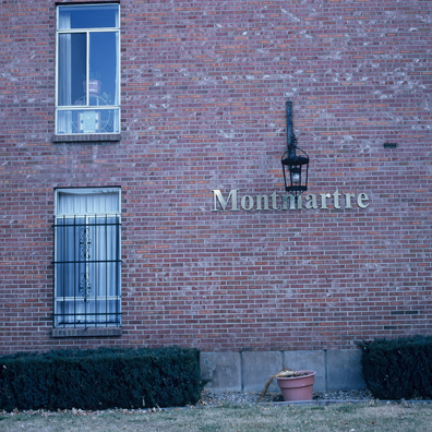 DISPLACED DENVER: THE MONMARTRE<br/>
2000 Ongoing <br/>
Cibachrome Print <br/>
Series of Denver Apartment Buildings Named After Famous Politicians, Artists, Landmarks, Neighborhoods, Beaches, Styles, Museums, Islands, Cocktails, Clothing, Pirates, Warriors, Automobiles, Restaurants, Race Tracks, Festivals, Writers, Cities, Explorers, Teams, Palaces, Stores, Poets, Song Writers, Hotels, Magazines, Fictional Places, Architectural Elements, Holidays, Etc <br/ >