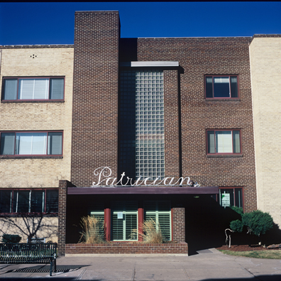 DISPLACED DENVER: THE PATRICIAN<br/>
2000 Ongoing <br/>
Cibachrome Print <br/>
Series of Denver Apartment Buildings Named After Famous Politicians, Artists, Landmarks, Neighborhoods, Beaches, Styles, Museums, Islands, Cocktails, Clothing, Pirates, Warriors, Automobiles, Restaurants, Race Tracks, Festivals, Writers, Cities, Explorers, Teams, Palaces, Stores, Poets, Song Writers, Hotels, Magazines, Fictional Places, Architectural Elements, Holidays, Etc <br/ >