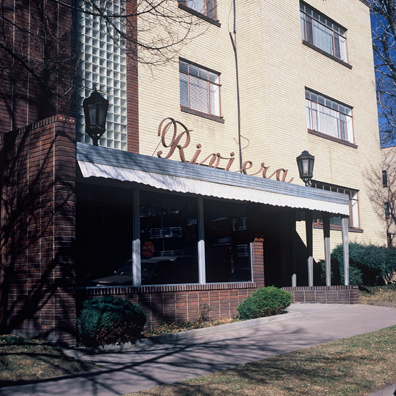 DISPLACED DENVER: THE RIVIERA<br/>
2000 Ongoing <br/>
Cibachrome Print <br/>
Series of Denver Apartment Buildings Named After Famous Politicians, Artists, Landmarks, Neighborhoods, Beaches, Styles, Museums, Islands, Cocktails, Clothing, Pirates, Warriors, Automobiles, Restaurants, Race Tracks, Festivals, Writers, Cities, Explorers, Teams, Palaces, Stores, Poets, Song Writers, Hotels, Magazines, Fictional Places, Architectural Elements, Holidays, Etc <br/ >