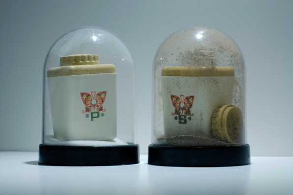 SHAKE: AN ACCUMULATED GIFT COLLECTION OF SALT AND PEPPER SHAKERS <br/>
1991 Ongoing <br/>
Detail: Gift of Geraldine Postel (Vintage Plastic Shakers with Butterfly)<br/>
Snow Globes Altered to Become Functioning Salt and Pepper Shakers, Each Filled with Salt and Pepper, and when Used, the Diminishing Salt and Pepper Reveals the Actual Accumulated Gift Collection of Shakers<br/>
3 1/2”H x 2 1/2” in Diameter<br/>