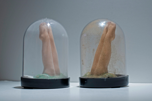 SHAKE: AN ACCUMULATED GIFT COLLECTION OF SALT AND PEPPER SHAKERS <br/>
1991 Ongoing <br/>
Detail: Gift of Sari Carel (Shakers in the Shape of Cancun Dancers' Legs)<br/>
Snow Globes Altered to Become Functioning Salt and Pepper Shakers, Each Filled with Salt and Pepper, and when Used, the Diminishing Salt and Pepper Reveals the Actual Accumulated Gift Collection of Shakers<br/>
3 1/2”H x 2 1/2” in Diameter<br/>