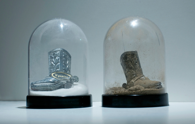 SHAKE: AN ACCUMULATED GIFT COLLECTION OF SALT AND PEPPER SHAKERS <br/>
1991 Ongoing <br/>
Detail: Gift of Riisa Dikeou (Wyoming State Cowboy Boot Shakers)<br/>
Snow Globes Altered to Become Functioning Salt and Pepper Shakers, Each Filled with Salt and Pepper, and when Used, the Diminishing Salt and Pepper Reveals the Actual Accumulated Gift Collection of Shakers<br/>
3 1/2”H x 2 1/2” in Diameter<br/>