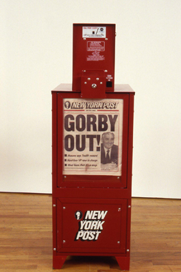 THE NEWS <br/>
1991 Ongoing <br/>
Detail: The New York Post; “Gorby Out”<br/>
Fully Operational New York Post Dispenser, Available for Viewers to Use for the Duration of the Exhibition, Papers Updated on Daily/Weekly Basis by Appropriate News Agencies <br/>
18” x 49” x 20” Each<br/>