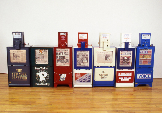 THE NEWS <br/>
1991 Ongoing <br/>
Series of Fully Operational New York City Newspaper Dispensers, Available for Viewers to Use for the Duration of the Exhibition, Papers Updated on Daily/Weekly Basis by Appropriate News Agencies <br/>
18” x 49” x 20” Each<br/>