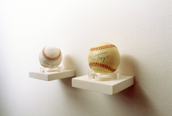 TOUCH OF GREATNESS: REGGIE JACKSON & WILLIE MAYS<br />
1994 Ongoing<br />
2 Autographed Baseballs from the Artist's Personal Collection: (To Devon: Reggie Jackson, Willie Mays)<br />
Left Unguarded on Shelves to Collect Viewer's Fingerprints, Diminishing in Value as Collectibles, while Increasing in Value as Art Objects<br />
Dimensions: Regulation National League Baseballs <br />
Unique, 1 AP<br />