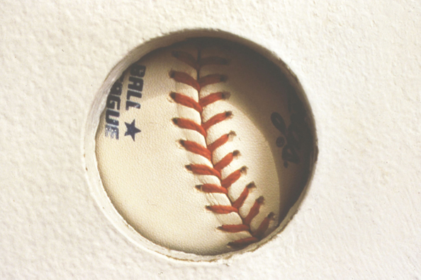 TOUCH OF GREATNESS: JOE DIMAGGIO<br/>
1994 Ongoing <br/>
Detail: Autograph Un-rotated<br/>
Autographed Baseball from the Artist's Personal Collection: Joe DiMaggio <br/>
Left Unguarded to Rotate Behind “The Hole” and Collection Viewer's Fingerprints, Diminishing in Value as a Collectible, while Increasing in Value as an Art Object <br/>
Dimensions: Regulation American League Baseball <br/>