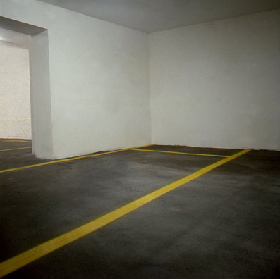“ASPHALT JUNGLE”: PAY HERE; KOLN<br />
1991 Ongoing<br />
Floor: Asphalt Installed on Top of Gallery Floor to Create Sections of 12 Spaces of an Abstract 100 Space Parking Lot‚ Parking Lines‚ and Numbers Painted on Asphalt to Delineate Parking Spaces<br />
Detail: Spaces 85, 86, 87<br />
Regulation Standard Parking Spaces<br />
Variable Dimensions<br />