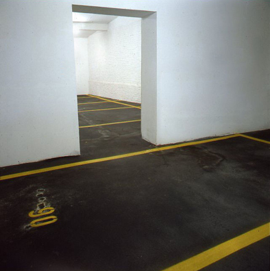 “ASPHALT JUNGLE”: PAY HERE; KOLN<br />
1991 Ongoing<br />
Floor: Asphalt Installed on Top of Gallery Floor to Create Sections of 12 Spaces of an Abstract 100 Space Parking Lot‚ Parking Lines‚ and Numbers Painted on Asphalt to Delineate Parking Spaces<br />
Detail: Spaces 85, 86, 97, 88, 89, 90, 91, 93, 94, 95, 96<br />
Regulation Standard Parking Spaces<br />
Variable Dimensions<br />
