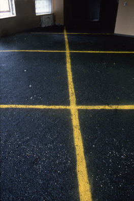 “ASPHALT JUNGLE”: PAY HERE; NY <br/>
1991 Ongoing <br/>
Floor: Asphalt Installed on Top of Gallery Floor to Create Sections of 8 Spaces of an Abstract 100 Space Parking Lot, Parking Lines, and Numbers Painted on Asphalt to Delineate Parking Spaces <br/>
Detail: Spaces 21, 22, 23, 24, 37, 38, 39, 40<br/>
Regulation Standard Parking Spaces <br/>
Variable Dimensions<br/>