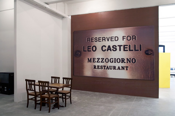 RESERVED FOR LEO CASTELLI: <i>SINCE CEZANNE</i> (After Clive Bell)<br />
2010 <br/>
Lateral View <br />
Wall: C-Print Wall Mural of Name Plate Reserving a Table in Perpetuity for the Preeminent Art Dealer Leo Castelli<br />
Floor: 2 Tables and 4 Chairs from the Restaurant Mezzogiorno<br />
Variable Dimensions<br />