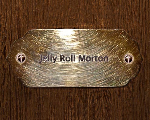 “MAMAS DON'T LET YOUR BABIES GROW UP TO BE COWBOYS”<br/>
Jelly Roll Morton<br/>
2009 ongoing <br/>
C-Print of a Name Plate Reserving a Hotel Room in Perpetuity for the Piano Jazz Legend, Jelly Roll Morton<br/>
Mounted on Wood with Non-Glare Plexiglas Surface<br/>
7 3/4” x 9 3/4” x 3/4” <br/>