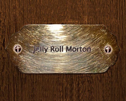 “MAMAS DON'T LET YOUR BABIES GROW UP TO BE COWBOYS”<br/>
Jelly Roll Morton<br/>
2009 ongoing <br/>
C-Print of a Name Plate Reserving a Hotel Room in Perpetuity for the Piano Jazz Legend, Jelly Roll Morton<br/>
Mounted on Wood with Non-Glare Plexiglas Surface<br/>
7 3/4” x 9 3/4” x 3/4” <br/>