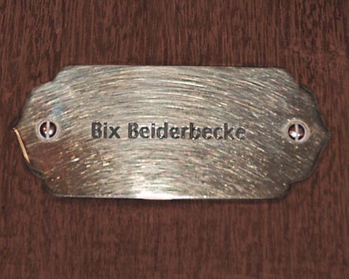 “MAMAS DON'T LET YOUR BABIES GROW UP TO BE COWBOYS”<br/>
Bix Beiderbecke<br/>
2009 ongoing <br/>
C-Print of a Name Plate Reserving a Hotel Room in Perpetuity for the Coronet/Piano Jazz Legend, Bix Beiderbecke<br/>
Mounted on Wood with Non-Glare Plexiglas Surface<br/>
7 3/4” x 9 3/4” x 3/4” <br/>