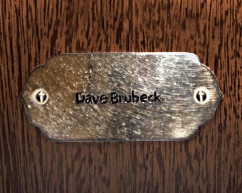 “MAMAS DON'T LET YOUR BABIES GROW UP TO BE COWBOYS”<br/>
Dave Brubeck<br/>
2009 ongoing <br/>
C-Print of a Name Plate Reserving a Hotel Room in Perpetuity for the Piano Jazz Legend, Dave Brubeck<br/>
Mounted on Wood with Non-Glare Plexiglas Surface<br/>
7 3/4” x 9 3/4” x 3/4” <br/>