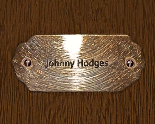 “MAMAS DON'T LET YOUR BABIES GROW UP TO BE COWBOYS”<br/>
Johnny Hodges<br/>
2009 ongoing <br/>
C-Print of a Name Plate Reserving a Hotel Room in Perpetuity for the Sax/Clarinet Jazz Legend, Johnny Hodges<br/>
Mounted on Wood with Non-Glare Plexiglas Surface<br/>
7 3/4” x 9 3/4” x 3/4” <br/>