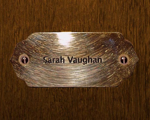 “MAMAS DON'T LET YOUR BABIES GROW UP TO BE COWBOYS”<br/>
Sarah Vaughan<br/>
2009 ongoing <br/>
C-Print of a Name Plate Reserving a Hotel Room in Perpetuity for the Songstress Jazz Legend, Sarah Vaughan<br/>
Mounted on Wood with Non-Glare Plexiglas Surface<br/>
7 3/4” x 9 3/4” x 3/4” <br/>