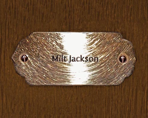 “MAMAS DON'T LET YOUR BABIES GROW UP TO BE COWBOYS”<br/>
Milt Jackson<br/>
2009 ongoing <br/>
C-Print of a Name Plate Reserving a Hotel Room in Perpetuity for the Vibraphone Jazz Legend, Milt Jackson<br/>
Mounted on Wood with Non-Glare Plexiglas Surface<br/>
7 3/4” x 9 3/4” x 3/4” <br/>