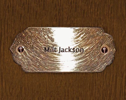 “MAMAS DON'T LET YOUR BABIES GROW UP TO BE COWBOYS”<br/>
Milt Jackson<br/>
2009 ongoing <br/>
C-Print of a Name Plate Reserving a Hotel Room in Perpetuity for the Vibraphone Jazz Legend, Milt Jackson<br/>
Mounted on Wood with Non-Glare Plexiglas Surface<br/>
7 3/4” x 9 3/4” x 3/4” <br/>