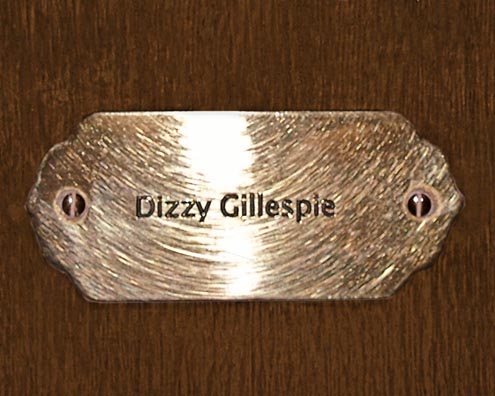 “MAMAS DON'T LET YOUR BABIES GROW UP TO BE COWBOYS”<br/>
Dizzy Gillespie<br/>
2009 ongoing <br/>
C-Print of a Name Plate Reserving a Hotel Room in Perpetuity for the Multifarious Jazz Legend, Dizzy Gillespie<br/>
Mounted on Wood with Non-Glare Plexiglas Surface<br/>
7 3/4” x 9 3/4” x 3/4” <br/>