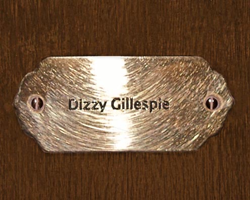 “MAMAS DON'T LET YOUR BABIES GROW UP TO BE COWBOYS”<br/>
Dizzy Gillespie<br/>
2009 ongoing <br/>
C-Print of a Name Plate Reserving a Hotel Room in Perpetuity for the Multifarious Jazz Legend, Dizzy Gillespie<br/>
Mounted on Wood with Non-Glare Plexiglas Surface<br/>
7 3/4” x 9 3/4” x 3/4” <br/>