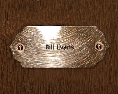 “MAMAS DON'T LET YOUR BABIES GROW UP TO BE COWBOYS”<br/>
Bill Evans<br/>
2009 ongoing <br/>
C-Print of a Name Plate Reserving a Hotel Room in Perpetuity for the Piano Jazz Legend, Bill Evans<br/>
Mounted on Wood with Non-Glare Plexiglas Surface<br/>
7 3/4” x 9 3/4” x 3/4” <br/>