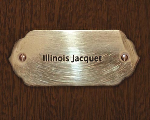 “MAMAS DON'T LET YOUR BABIES GROW UP TO BE COWBOYS”<br/>
Illinois Jacquet<br/>
2009 ongoing <br/>
C-Print of a Name Plate Reserving a Hotel Room in Perpetuity for the Multifarious Jazz Legend, Illinois Jacquet<br/>
Mounted on Wood with Non-Glare Plexiglas Surface<br/>
7 3/4” x 9 3/4” x 3/4” <br/>