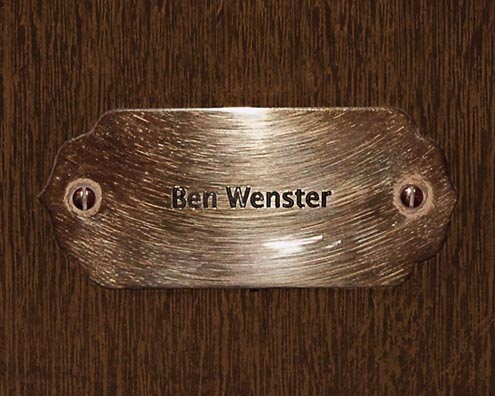 “MAMAS DON'T LET YOUR BABIES GROW UP TO BE COWBOYS”<br/>
Ben Wenster [Sic] <br/>
2009 ongoing <br/>
C-Print of a Name Plate Reserving a Hotel Room in Perpetuity for the Tenor Sax Jazz Legend, Ben Webster<br/>
Mounted on Wood with Non-Glare Plexiglas Surface<br/>
7 3/4” x 9 3/4” x 3/4” <br/>