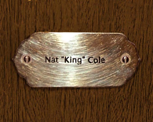 “MAMAS DON'T LET YOUR BABIES GROW UP TO BE COWBOYS”<br/>
Nat “King” Cole<br/>
2009 ongoing <br/>
C-Print of a Name Plate Reserving a Hotel Room in Perpetuity for the Songster/Piano Jazz Legend, Nat King Cole<br/>
Mounted on Wood with Non-Glare Plexiglas Surface<br/>
7 3/4” x 9 3/4” x 3/4” <br/>