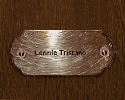 “MAMAS DON'T LET YOUR BABIES GROW UP TO BE COWBOYS”<br/>
Lennie Tristano<br/>
2009 ongoing <br/>
C-Print of a Name Plate Reserving a Hotel Room in Perpetuity for the Multifarious Jazz Legend, Lennie Tristano<br/>
Mounted on Wood with Non-Glare Plexiglas Surface<br/>
7 3/4” x 9 3/4” x 3/4” <br/>