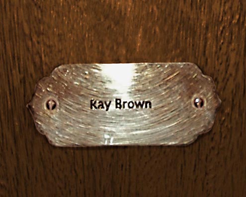 “MAMAS DON'T LET YOUR BABIES GROW UP TO BE COWBOYS”<br/>
Ray Brown<br/>
2009 ongoing <br/>
C-Print of a Name Plate Reserving a Hotel Room in Perpetuity for the Double/Electric Bass Jazz Legend, Ray Brown<br/>
Mounted on Wood with Non-Glare Plexiglas Surface<br/>
7 3/4” x 9 3/4” x 3/4” <br/>