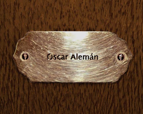 “MAMAS DON'T LET YOUR BABIES GROW UP TO BE COWBOYS”<br/>
Oscar Alemán<br/>
2009 ongoing <br/>
C-Print of a Name Plate Reserving a Hotel Room in Perpetuity for the Guitar Jazz Legend, Oscar Alemán<br/>
Mounted on Wood with Non-Glare Plexiglas Surface<br/>
7 3/4” x 9 3/4” x 3/4” <br/>