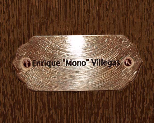 “MAMAS DON'T LET YOUR BABIES GROW UP TO BE COWBOYS”<br/>
Enrique “Mono” Villegas<br/>
2009 ongoing <br/>
C-Print of a Name Plate Reserving a Hotel Room in Perpetuity for the Piano Jazz Legend, Enrique “Mono” Villegas<br/>
Mounted on Wood with Non-Glare Plexiglas Surface<br/>
7 3/4” x 9 3/4” x 3/4” <br/>