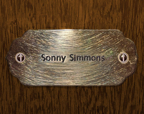 “MAMAS DON'T LET YOUR BABIES GROW UP TO BE COWBOYS”<br/>
Sonny Simmons<br/>
2009 ongoing <br/>
C-Print of a Name Plate Reserving a Hotel Room in Perpetuity for the Alto Sax/English Horn Jazz Legend, Sonny Simmons<br/>
Mounted on Wood with Non-Glare Plexiglas Surface<br/>
7 3/4” x 9 3/4” x 3/4” <br/>