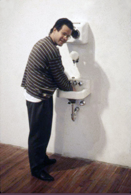 “COME YOU SPIRITS, WHICH TEND ON MORTAL THOUGHTS” - <i> Macbeth, </i> Shakespeare<br />
1993 Ongoing<br />
Happening: Functioning Kohler Sink, Soap Dispenser, and Air Dryer Installed in Gallery and Being Used by Kenny Schachter to Soap, Wash, and Dry His Hands<br />
Photograph of Happening <br />
Variable Dimensions<br />