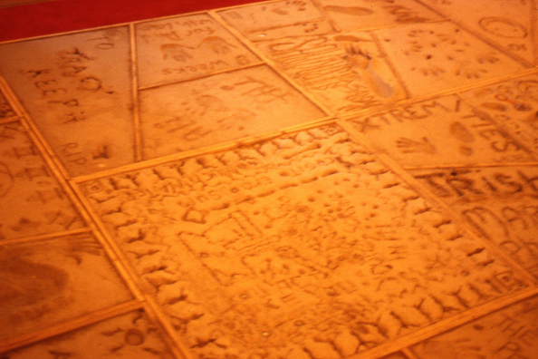NORMA TALMADGE'S CHINESE THEATER: LA<br />
1992 Ongoing<br />
Floor: Overview of Viewers' Cement Imprints, Red Carpeting<br />
Variable Dimensions<br />