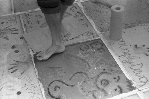 NORMA TALMADGE'S CHINESE THEATER: LA<br />
1992 Ongoing<br />
Happening: Viewers Immortalizing Themselves by Making Imprints in Fresh Cement in Homage to Forgotten Silent Diva, Norma Talmadge, the Accidental Auteur of the Canonical Practice<br />
Photograph of Happening Displayed in Collector's Edition Photograph Book: “The Sign on the Door” (1921)<br />
4” x 6”<br />